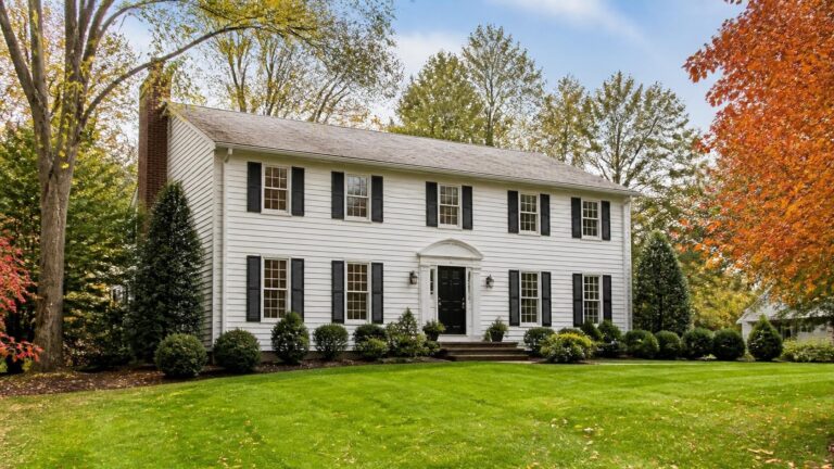 Two-story colonial home with a brick chimney in a leafy New Jersey suburb
